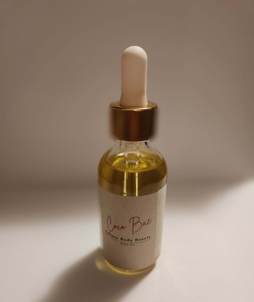 Coco Bae Body Oil bottle with dropper, cruelty-free blend for smooth, nourished skin with a subtle chocolate scent.